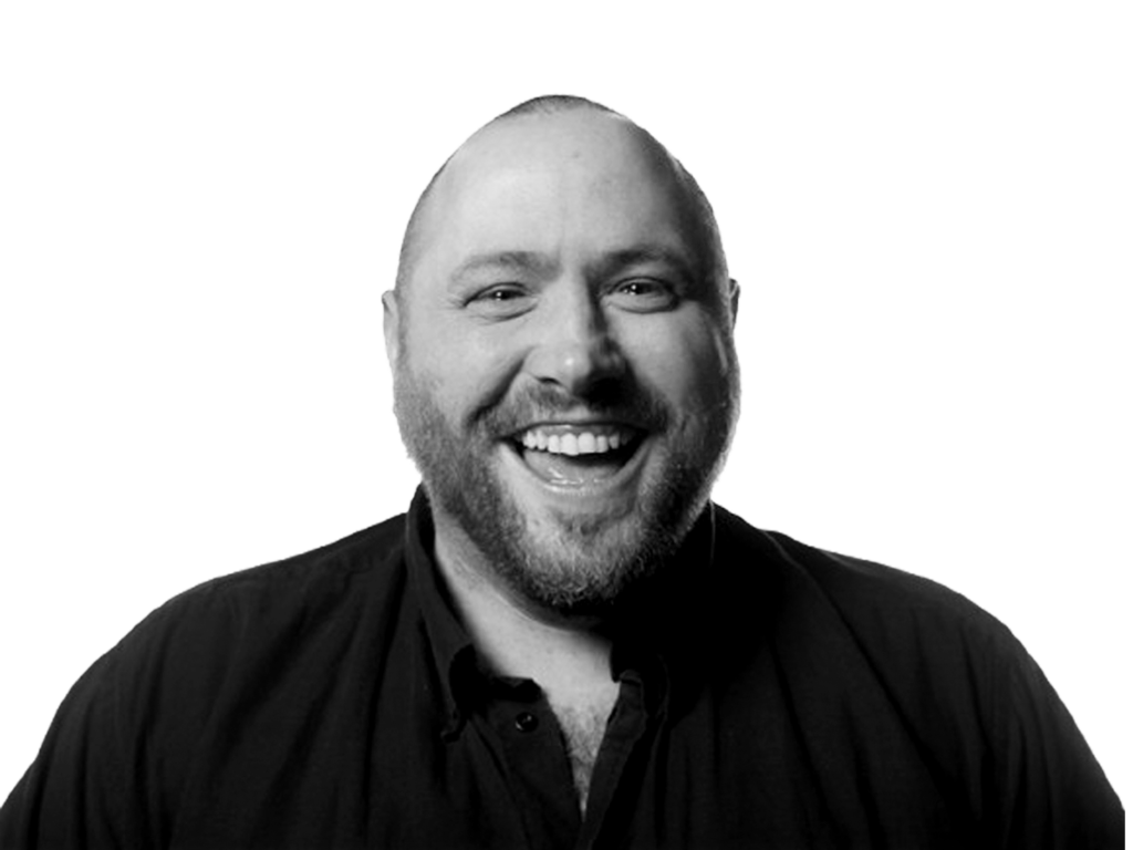 Mark Dickson, The Digital Learning Consultant – black and white headshot of Mark laughing in a dark shirt.